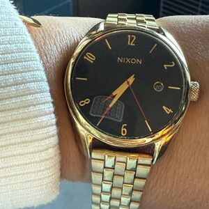 Nixon Gold and Black Wearable Watch